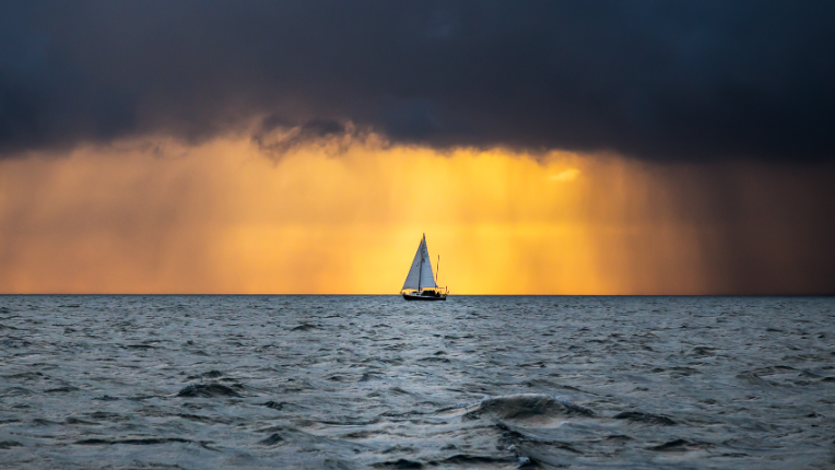 Boat sailing into the storm