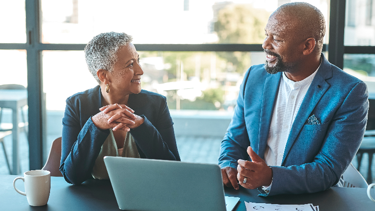 A photo of an advisor talking to a client.