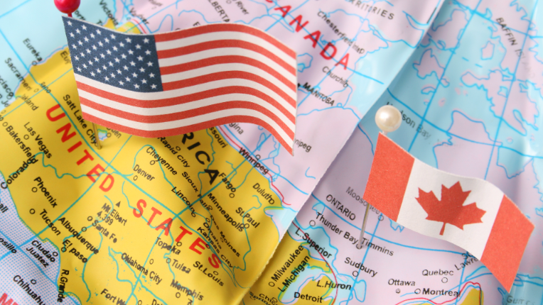 Canada and US flags on a map,