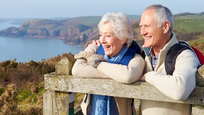 Retired couple overlooking coastal landscape